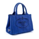 Prada Blue Canvas Denim Tote PM. Gold tone hardware. Interior of canvas with one zippered pocket an