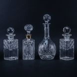 Collection of Four (4) Crystal Decanters. Unsigned. "AS IS" condition with chips from use. Tallest