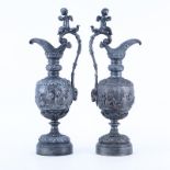 Pair of 20th Century Neoclassical Style Metal Ewers with Bacchanalian scenes. Rubbing otherwise goo