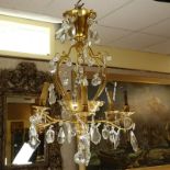 Late 19th/Early 20th Century Rococo Style Gilt Bronze and Crystal 6-Arm Chandelier. Decorated with