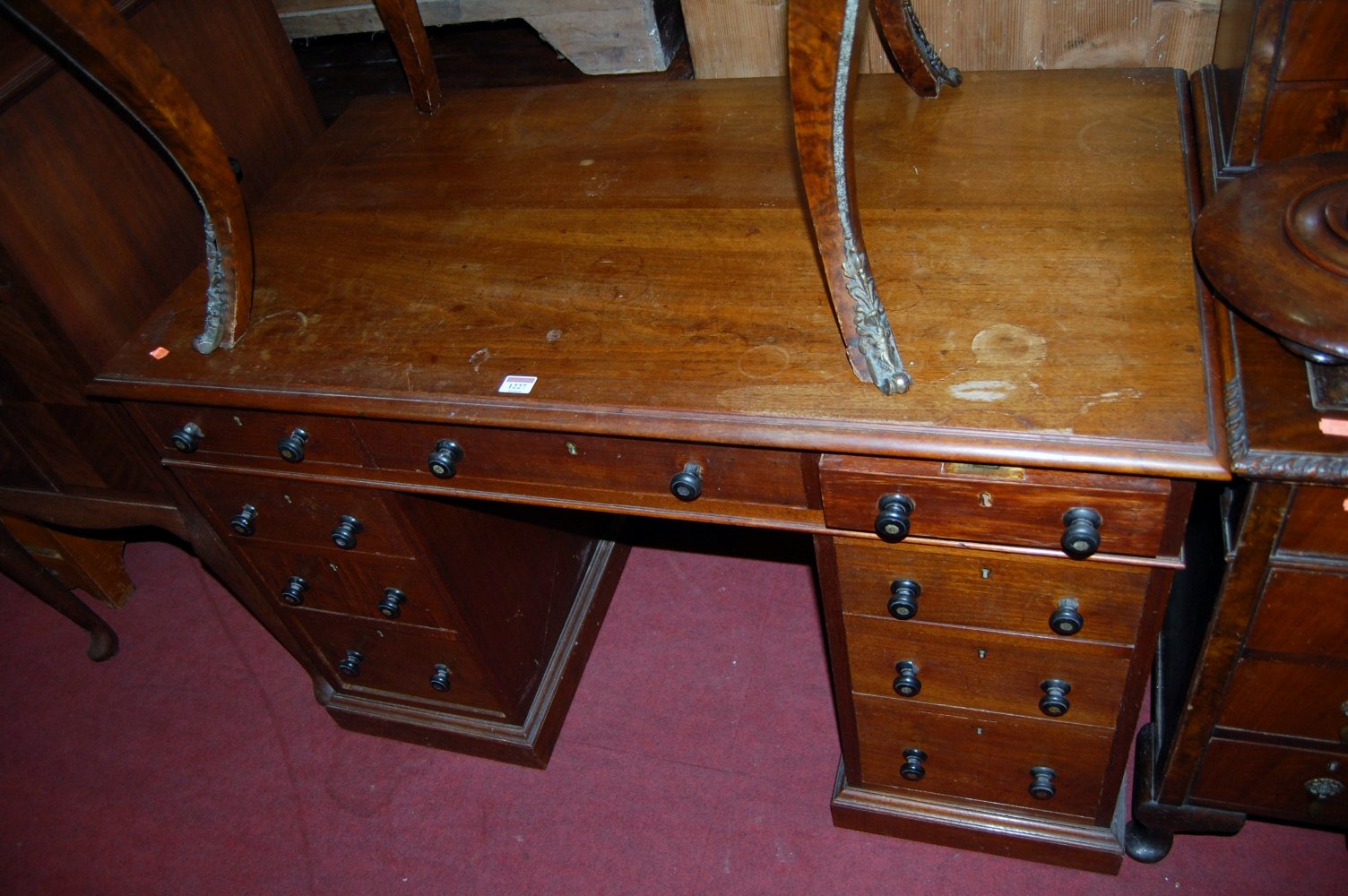 A Victorian mahogany twin pedestal writing desk having typical arrangement of nine long drawers