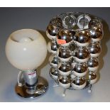 A contemporary chromed metal table lamp with glass globe shade,