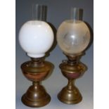 Two early 20th century brass oil lamps with additional etched globe and chimney (3)