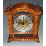 A walnut and gilt metal mounted mantel clock having a striking and chiming movement in the