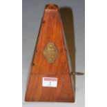 An early 20th century walnut cased metronome with hexagonal brass label