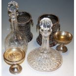 Two cut glass crystal decanters and stoppers, together with a pair of silver plated wine coasters,