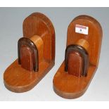 A pair of Art Deco oak bookends each of arched form