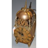 A reproduction brass lantern clock