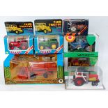 Seven various boxed or plastic cased tractor diecasts or farming implements,