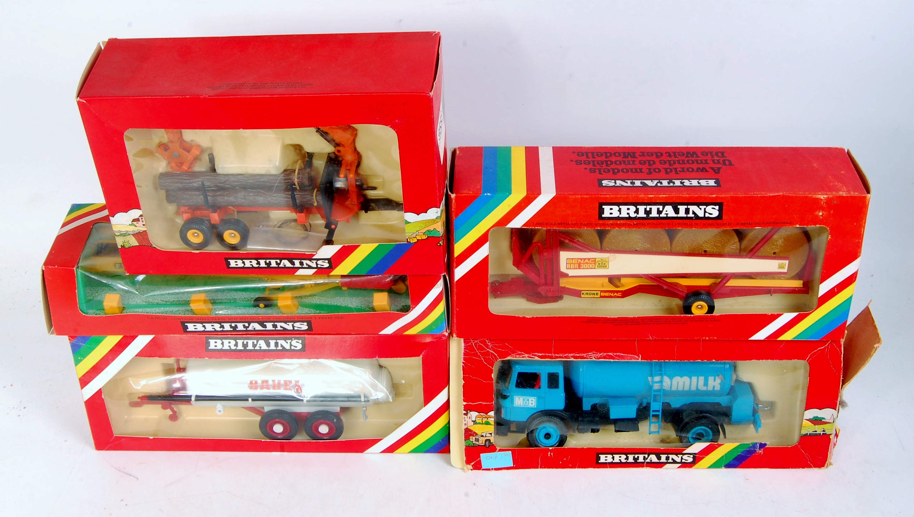 Five boxed Britains modern release farming implements, all in original rainbow window boxes,