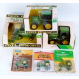 Six various boxed and carded ERTL mixed scale John Deere diecast tractors and farming accessories,