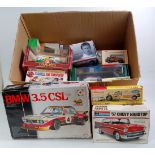 A large box containing a mixture of various modern issue diecast and part complete plastic kits to