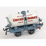 Hornby 1929-30 completely repainted 'United Dairies' milk tank wagon on grey-blue open axle guard