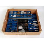 A small tray containing 4x plastic trays of small spare parts including buffers, couplings,