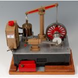 A wooden cased model of a beam engine powered by a stirling cycle hot air engine with spirit burner