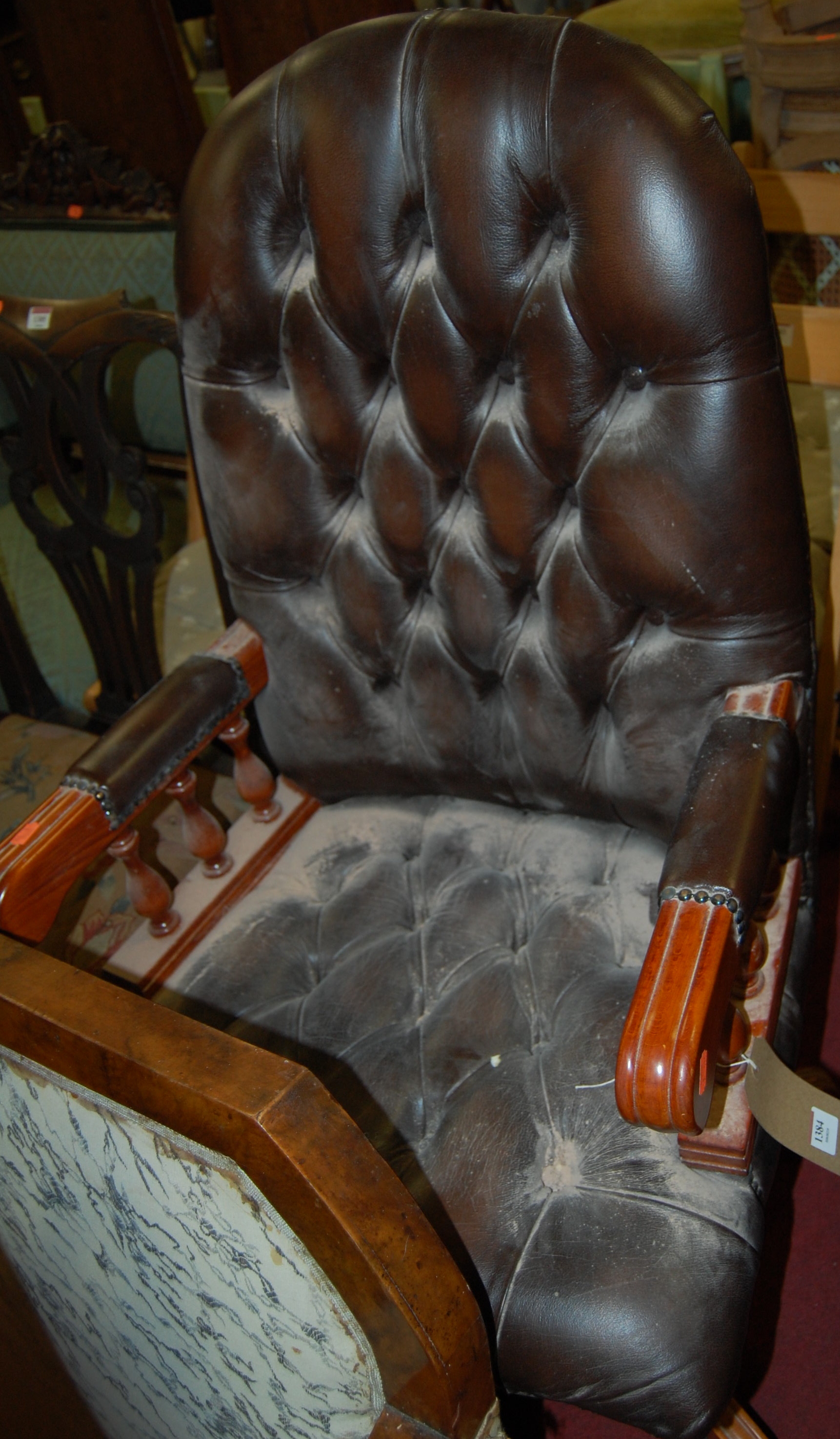 A contemporary chocolate brown leather upholstered buttoned and studded swivel desk chair