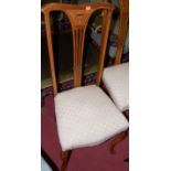 A set of four walnut and floral inlaid splatback bedroom chairs each having cream floral