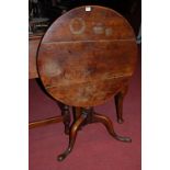 A George III mahogany circular tilt top pedestal tripod table, dia.