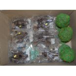 A box of mixed plastic and resin toys to include field canons and cherry trees