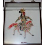 A Chinese painted "donkey hide" shadow puppet in glazed frame depicting warrior on horseback,