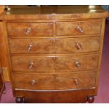 A mid Victorian mahogany and flame mahogany bowfront chest of two short over three long drawers on