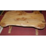 A contemporary burr elm shaped low coffee table,