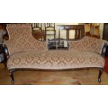 A late Victorian mahogany and floral upholstered chaise longue of serpentine form with floral