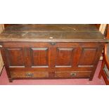 An early 18th century joined oak four panelled hinge top mule chest having later twin lower drawers,