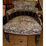 A late Victorian walnut and floral button back upholstered tub eblow chair