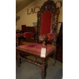 A late 19th century heavily carved oak and barley twist turned open armchair having upholstered pad