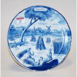 An early 20th century Dutch Delft blue & white calendar plate typically decorated with figures