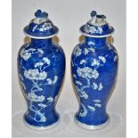 A pair of Chinese export stoneware blue and white jars and covers, each of baluster form,