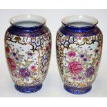 A pair of reproduction Chinese style vases of baluster form decorated with roses within gilt