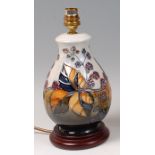 A contemporary Moorcroft Pottery table lamp, in the Bramble pattern, of bulbous lower form,