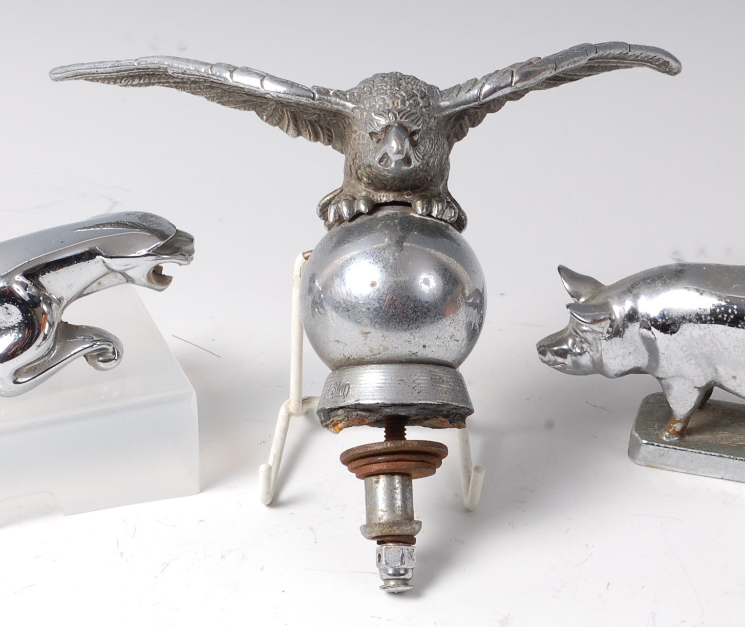 A Desmo chrome car mascot, modelled as an eagle perched on a globe, stamped 'Desmo',