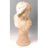 A large Art Nouveau painted plaster pedestal bust of a young woman,