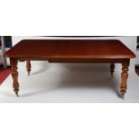 A Victorian mahogany extending dining table, the top having pull-out action, three extra leaves,