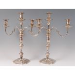 A pair of silver pedestal three light candelabra, in the early 18th century style,