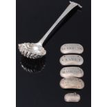 An early George III silver sifting spoon, having pierced shell shaped bowl to shell scroll terminal,