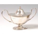 An Edwardian Irish silver twin handled tureen and cover, of plain undecorated oval form,