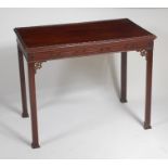 An antique mahogany silver table, having a beaded and moulded edge, blind carved frieze,