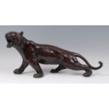 A Japanese Meiji period bronze tiger, naturalistically modelled in growling pose,