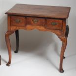 An 18th century walnut topped and fruitwood lowboy, having three frieze drawers,