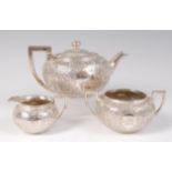 A Victorian silver bachelors three piece tea-set, comprising teapot, twin handled sugar and cream,