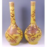 A pair of 19th century Japanese earthenware yellow ground bottle vases, of good size,