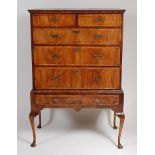 An early 19th century walnut chest, on associated stand (stand with later supports),