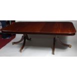 An antique mahogany twin pedestal dining table, the top having a moulded plain frieze,