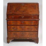 An 18th century walnut and figured walnut bureau, in two sections (probably a marriage),