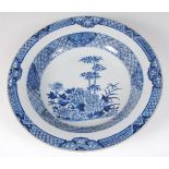 A Chinese export blue and white charger, decorated with bamboo within lattice worked borders,