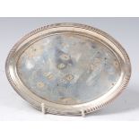 A George III silver teapot stand, of plain oval form within a reeded edge,